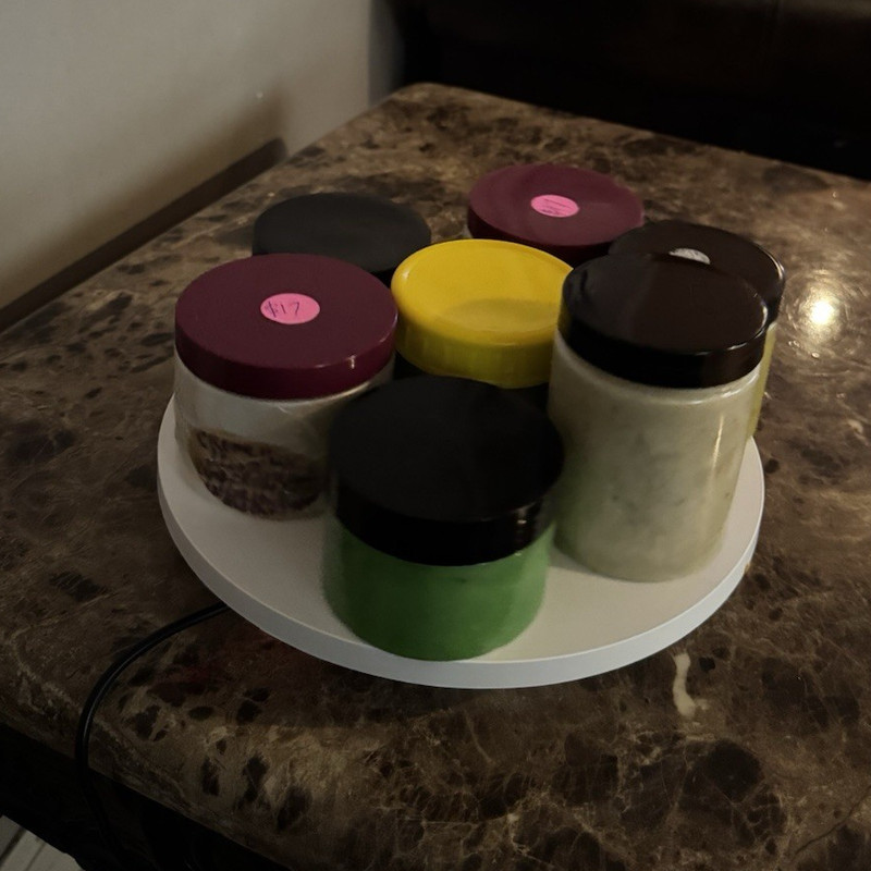 Homemade natural herbal hair growth grease with different Sizes jars.